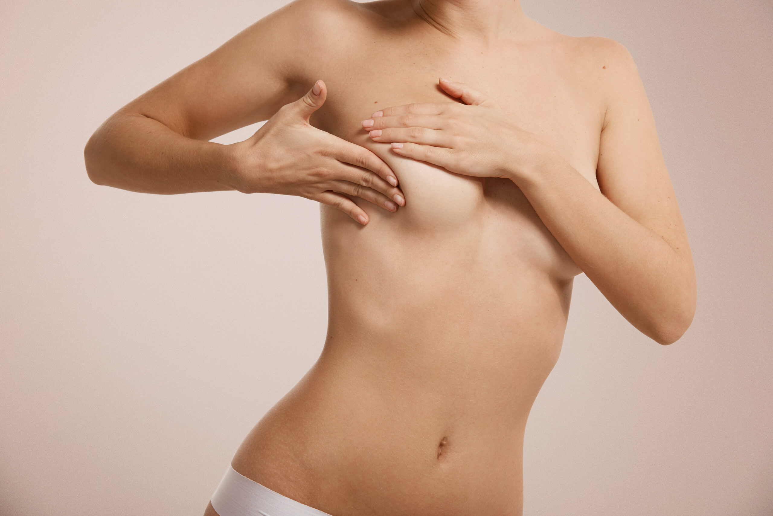 Breast cancer concept - woman checking her breast